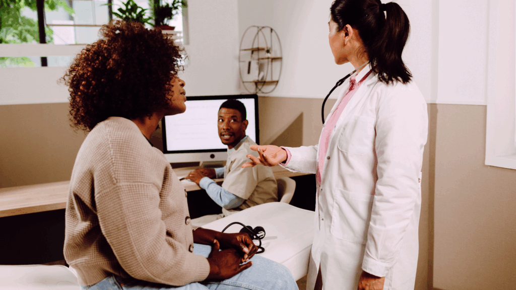 Nurse practitioner engaging with a patient while a scribe documents the visit, illustrating strong medical scribe ROI